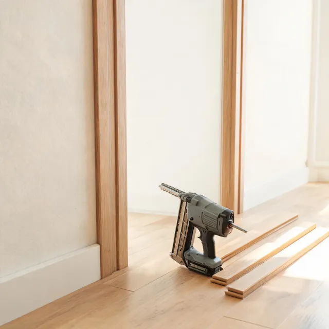 Angled finish nailer near trim work